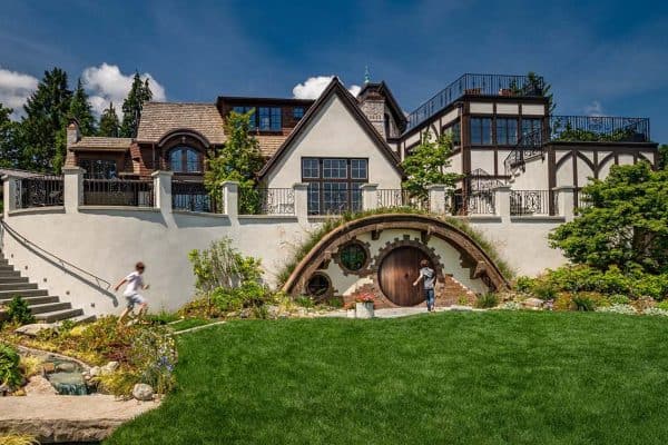 Tudor home with a hobbit door and landscaping
