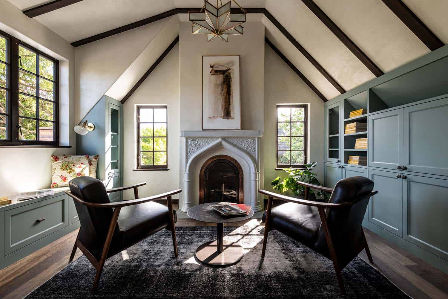 Tudor style living room with a fireplace and built-in window reading nook
