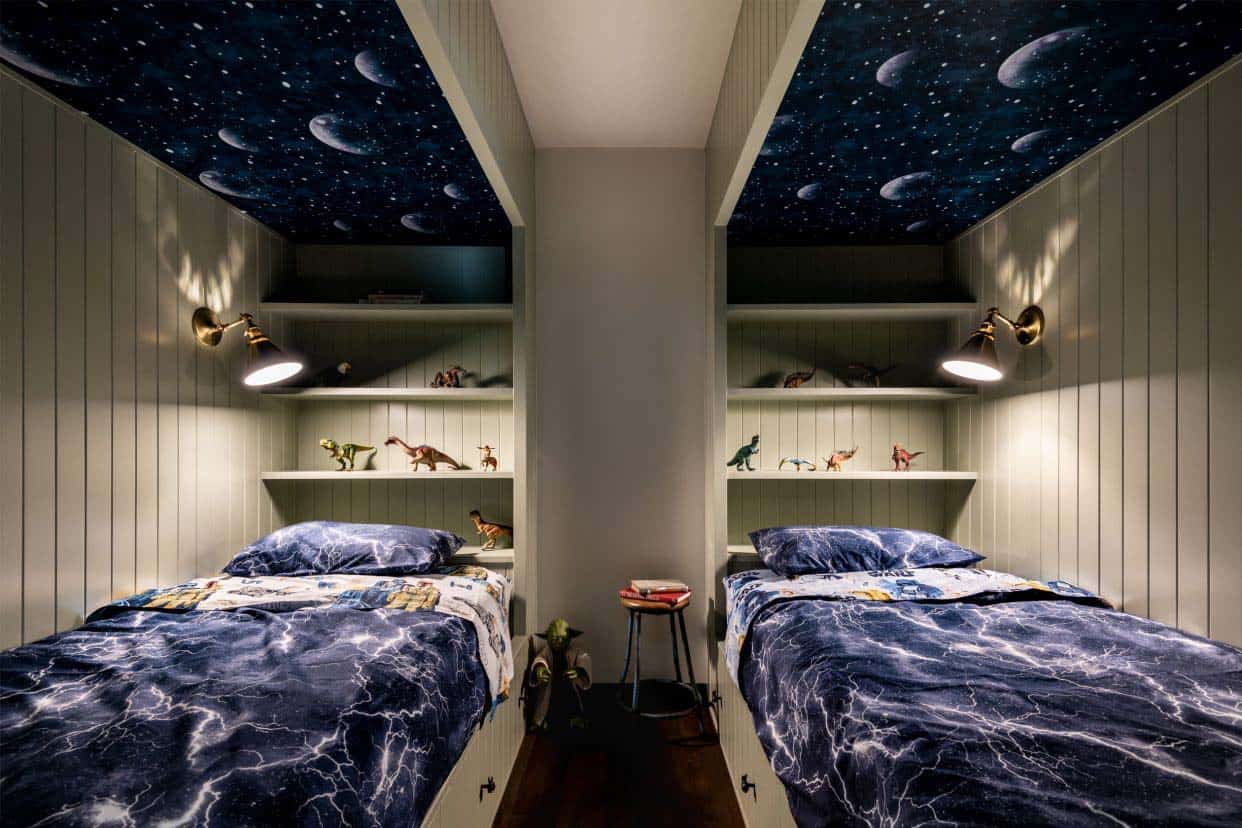 kids bedroom with custom built-in beds and galaxy wallpaper on the ceiling