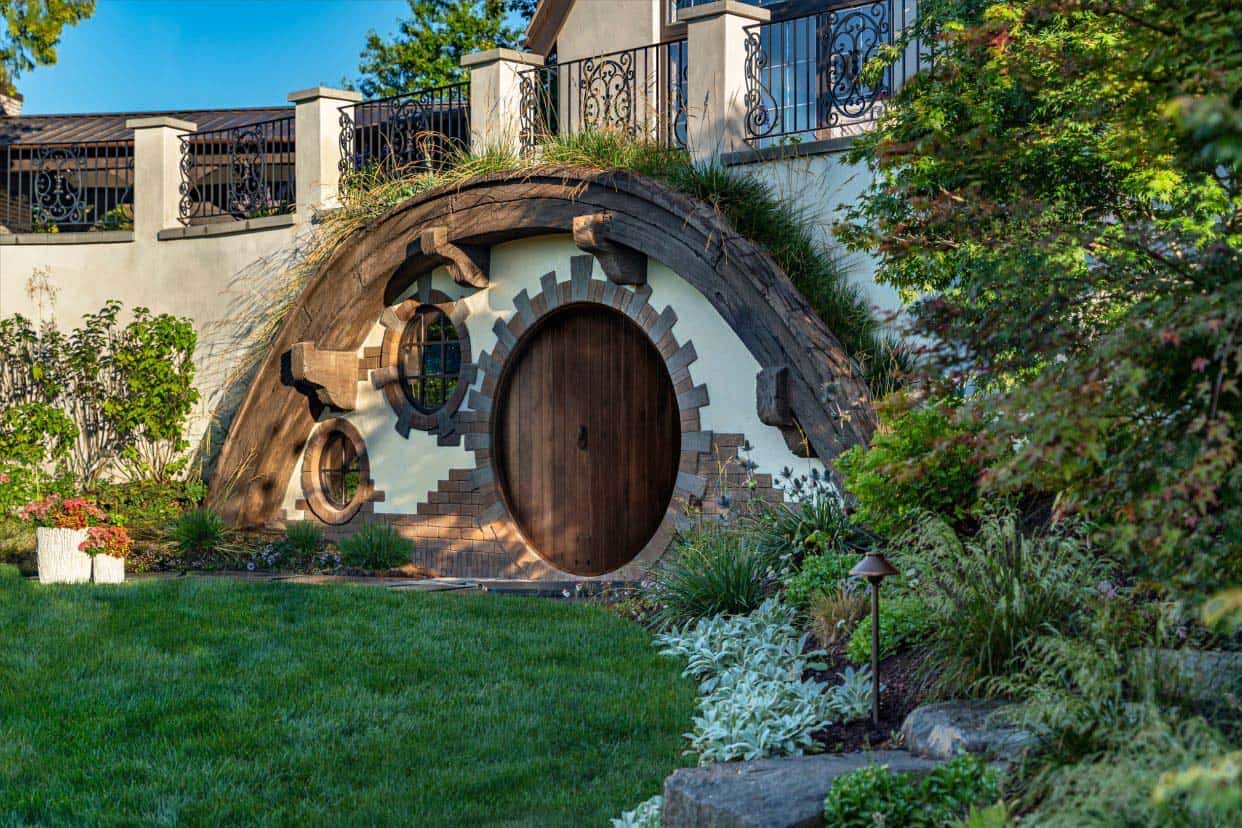 Tudor home with a hobbit door and landscaping