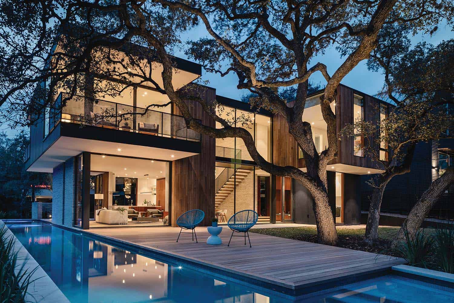 modern house exterior at dusk with a view of the pool