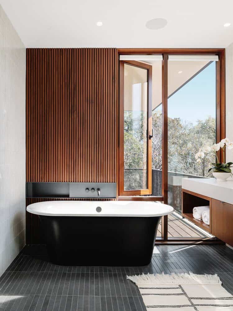 modern bathroom with a freestanding tub and operable window