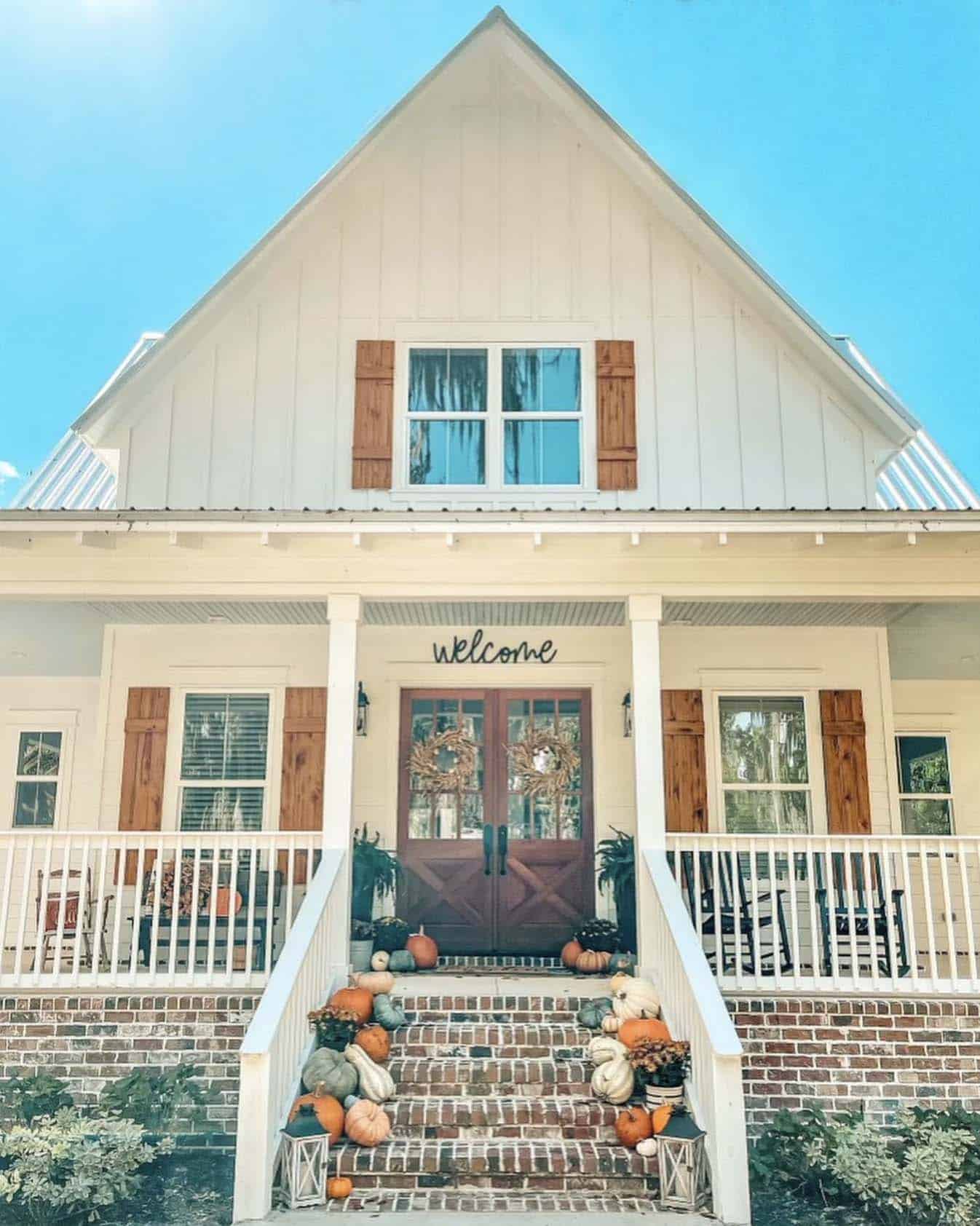 fall decorated front porch with stacked pumpkins