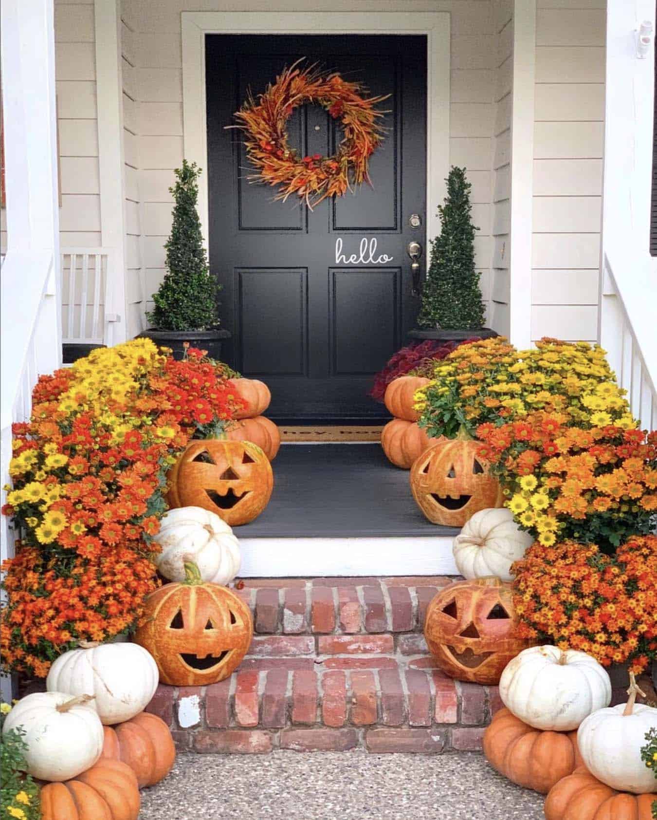 fall front porch with pumpkins and mums