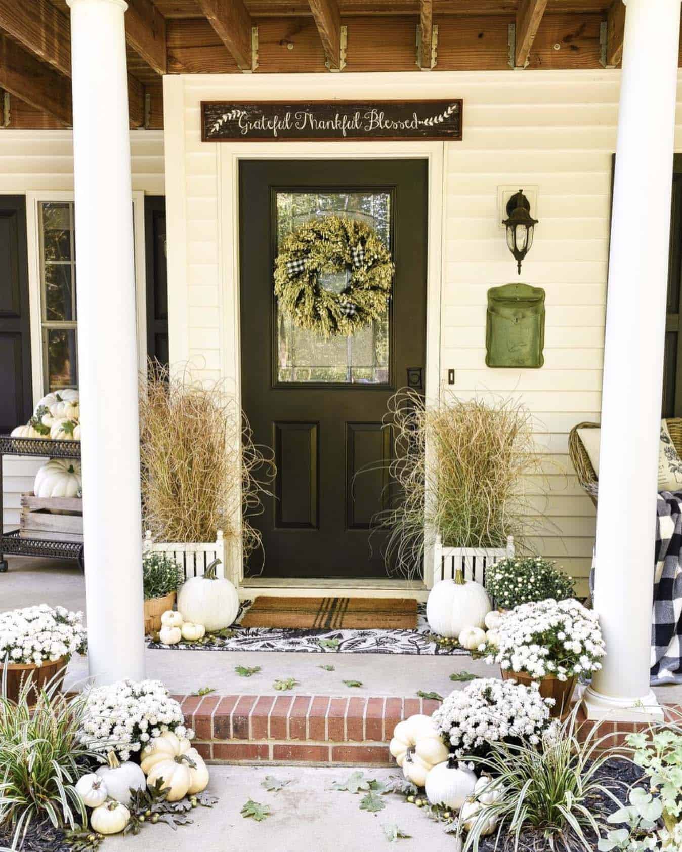 farmhouse style home entry with white pumpkins and mums