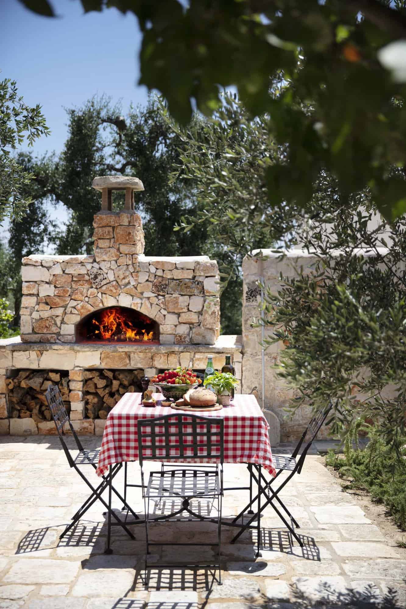 outdoor dining table with a pizza oven