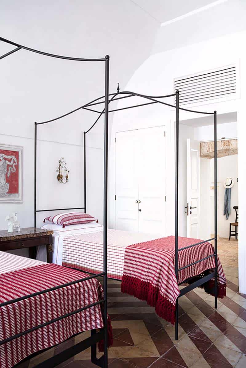 contemporary guest bedroom with two canopy beds