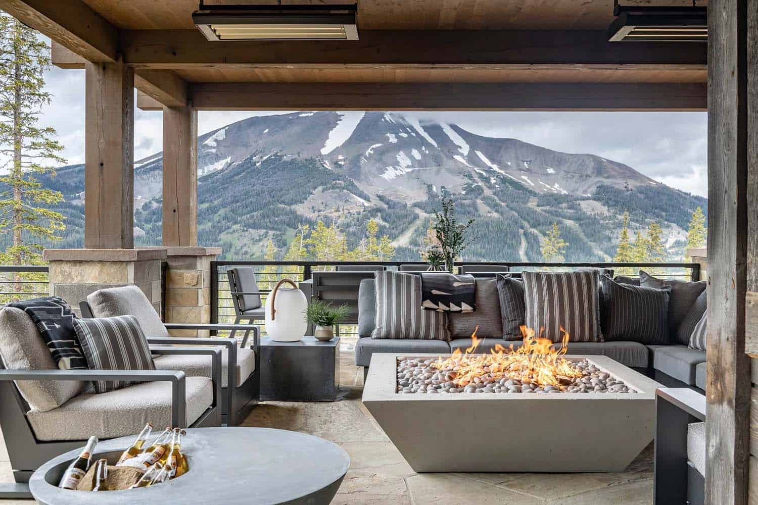 contemporary mountain home covered patio with a fire pit