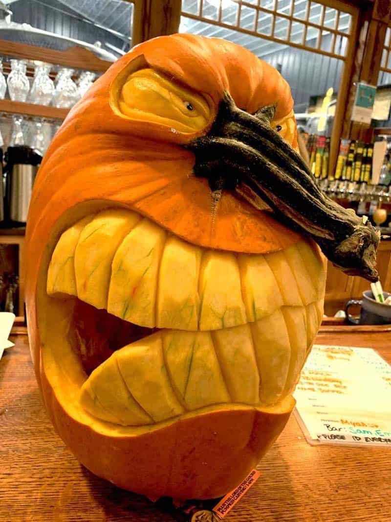 pumpkin carving idea with a scary face and the stock as the nose