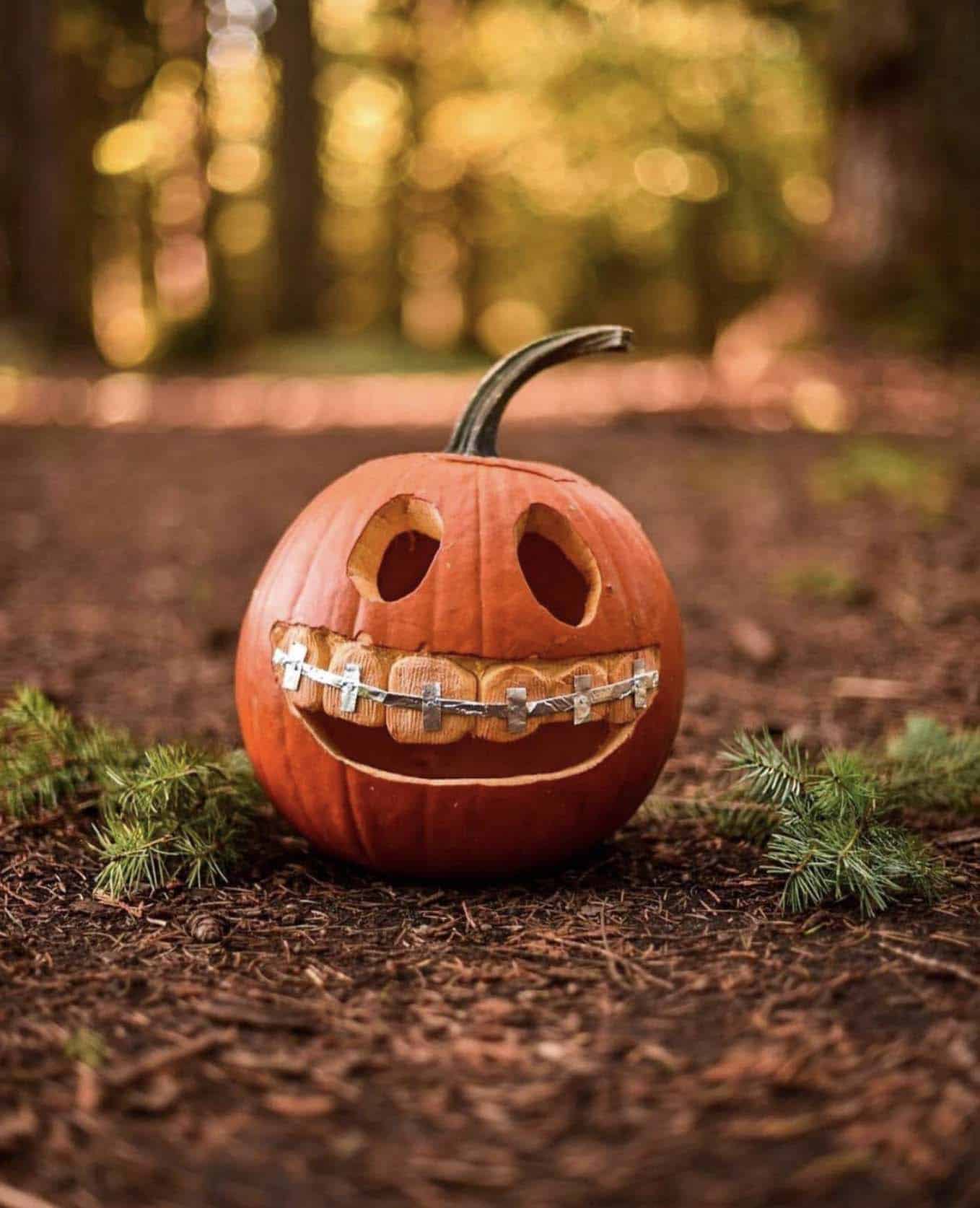 Halloween monster carved out in a pumpkin with tooth braces