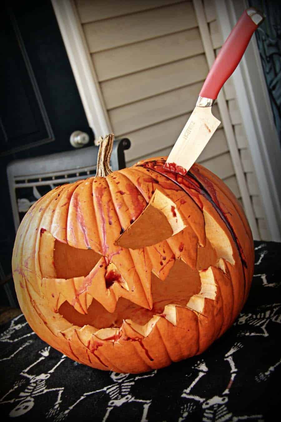 scary pumpkin with a knife and faux blood