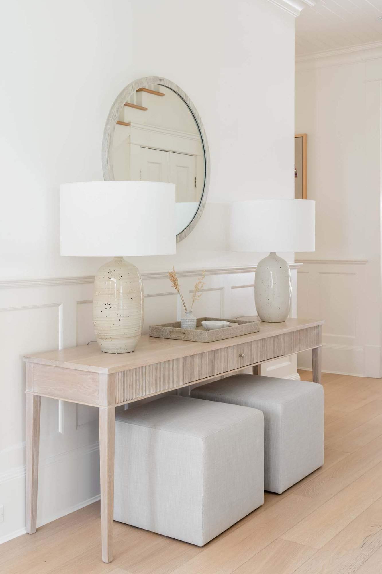 transitional foyer with a console table