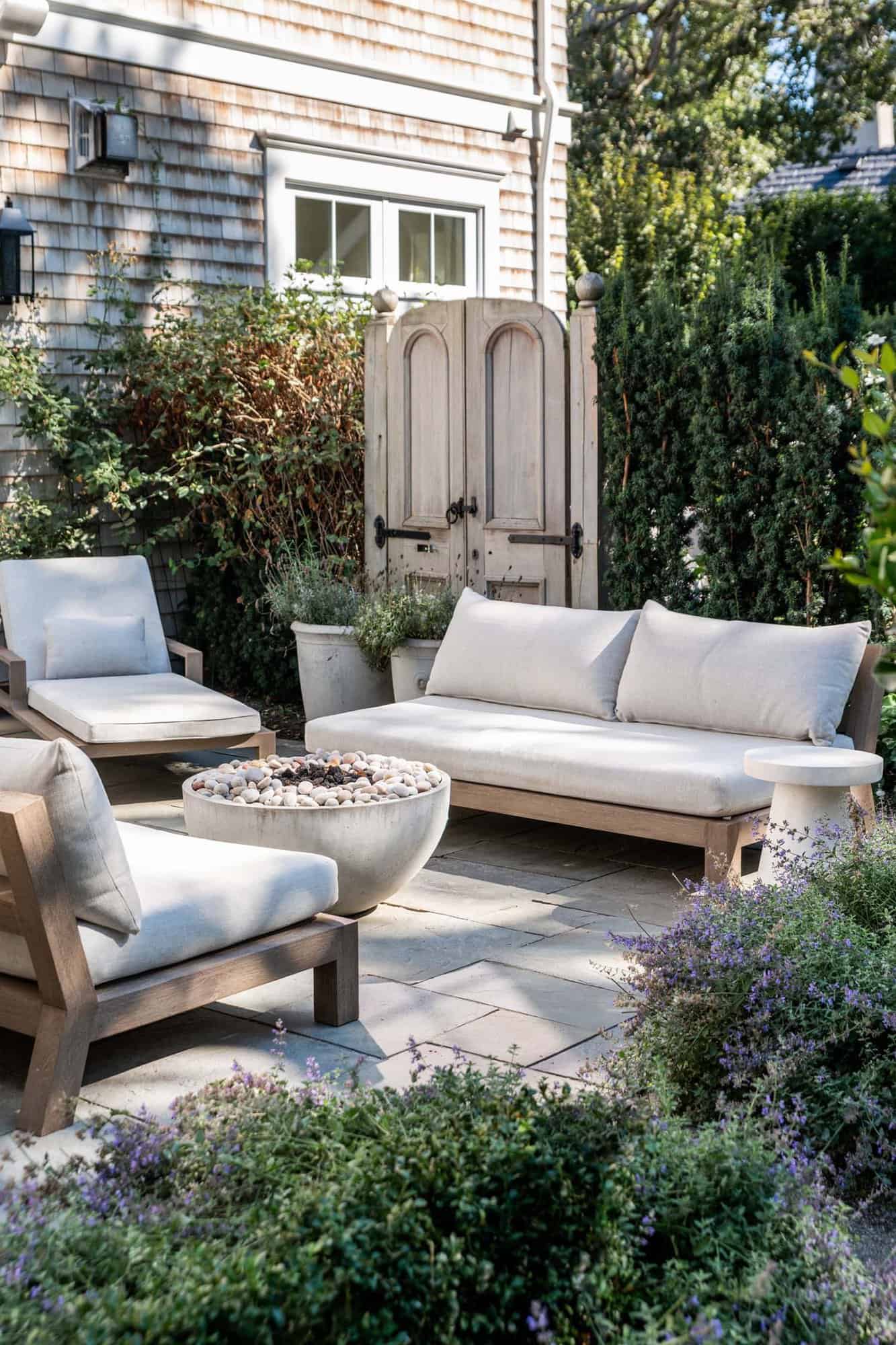elegant oceanfront home backyard patio with outdoor furniture