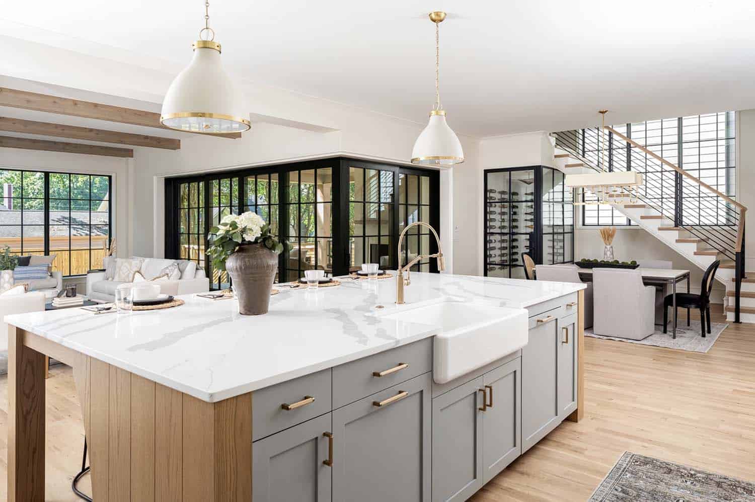 transitional kitchen with gray and wood tone cabinetry on the island