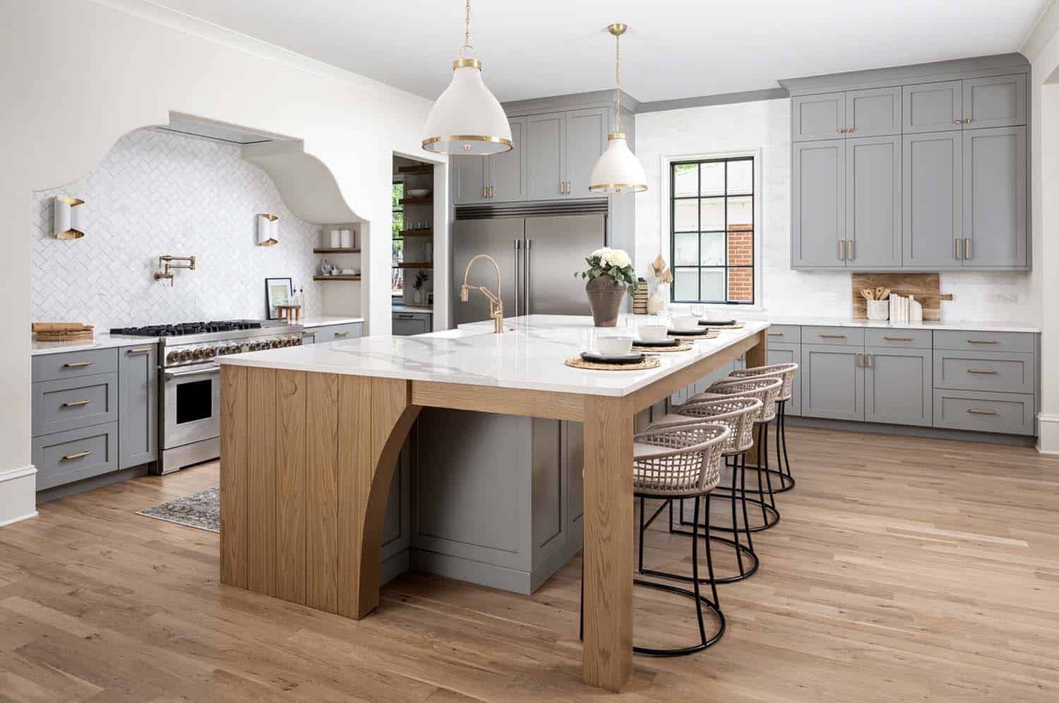 transitional kitchen with gray and wood tone cabinetry on the island
