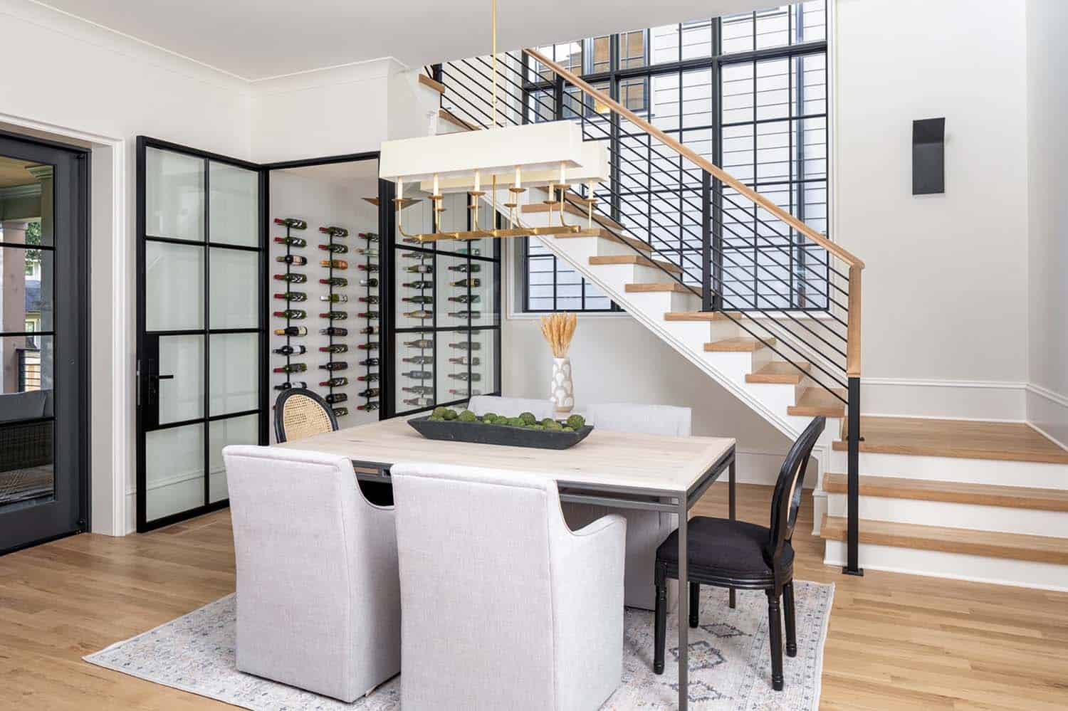 transitional dining room with wine storage underneath the staircase