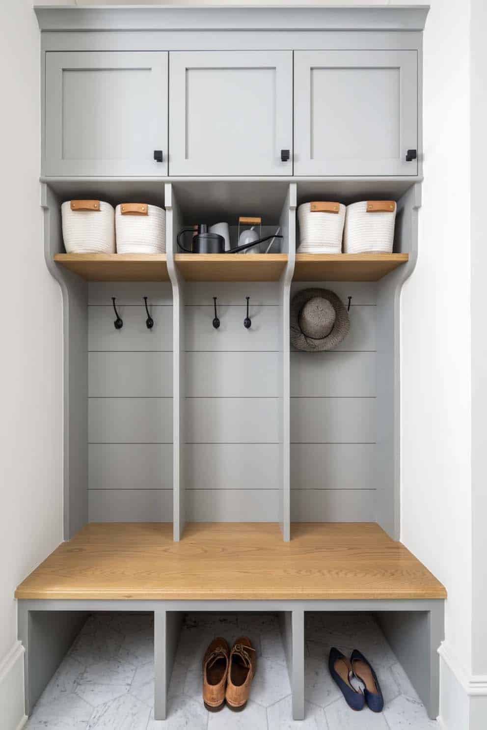 transitional mudroom with built-in cubbies, hooks, and storage