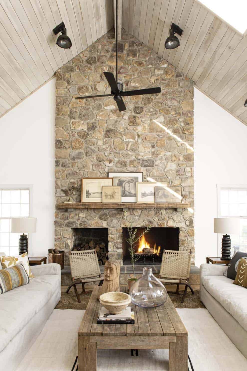 farmhouse living room with a stone clad fireplace