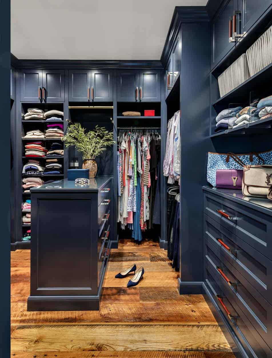 beach style walk-in closet with blue cabinetry