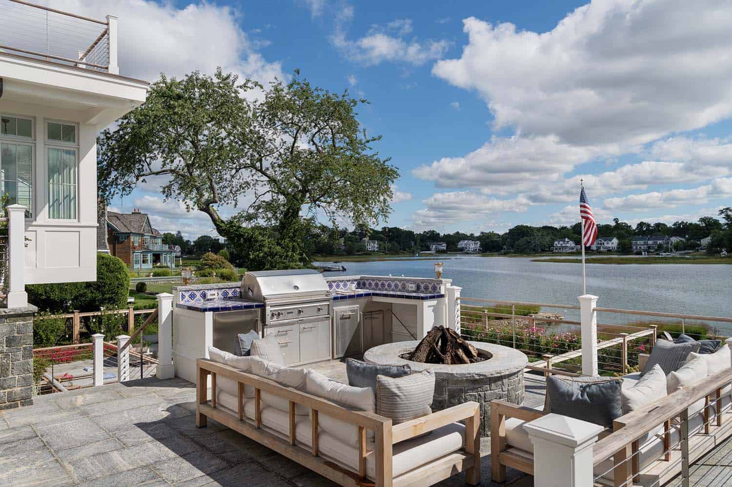 waterfront home patio with outdoor furniture and a fire pit