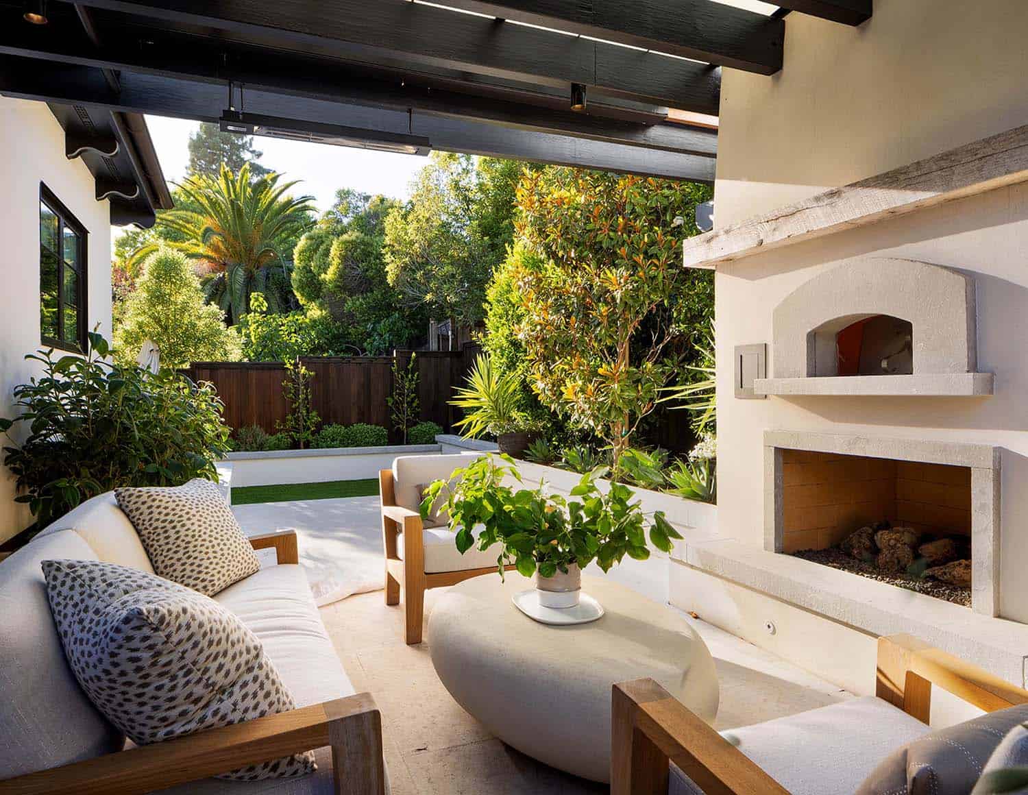 transitional patio with a fireplace and outdoor furniture