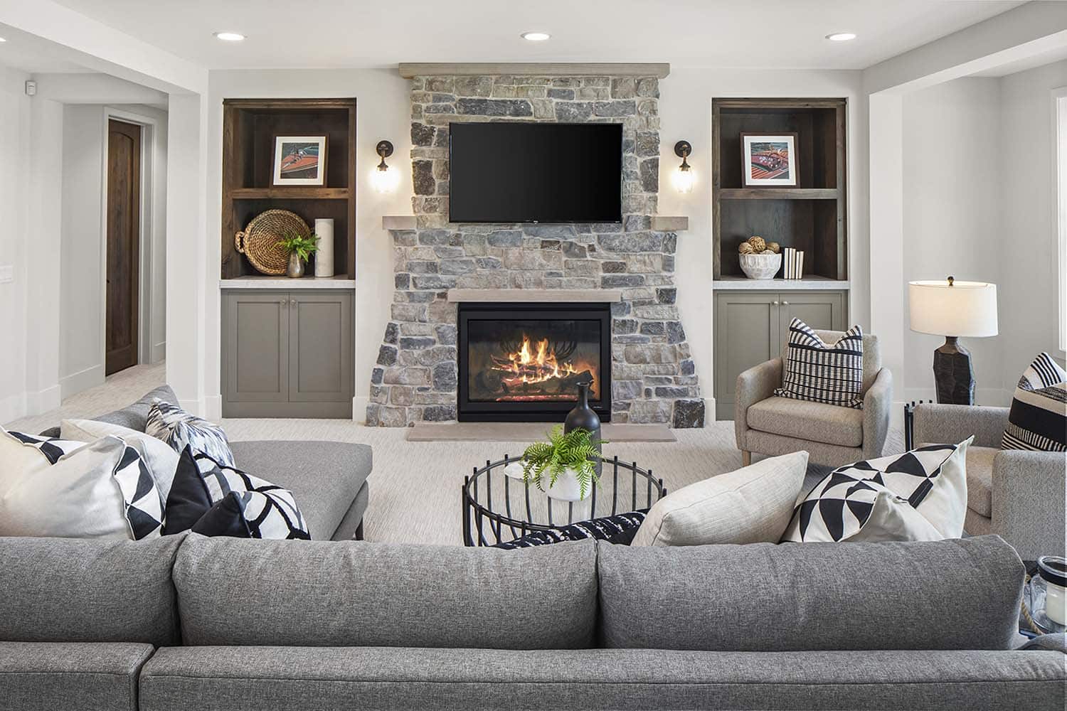 modern family room with a fireplace on the lower level