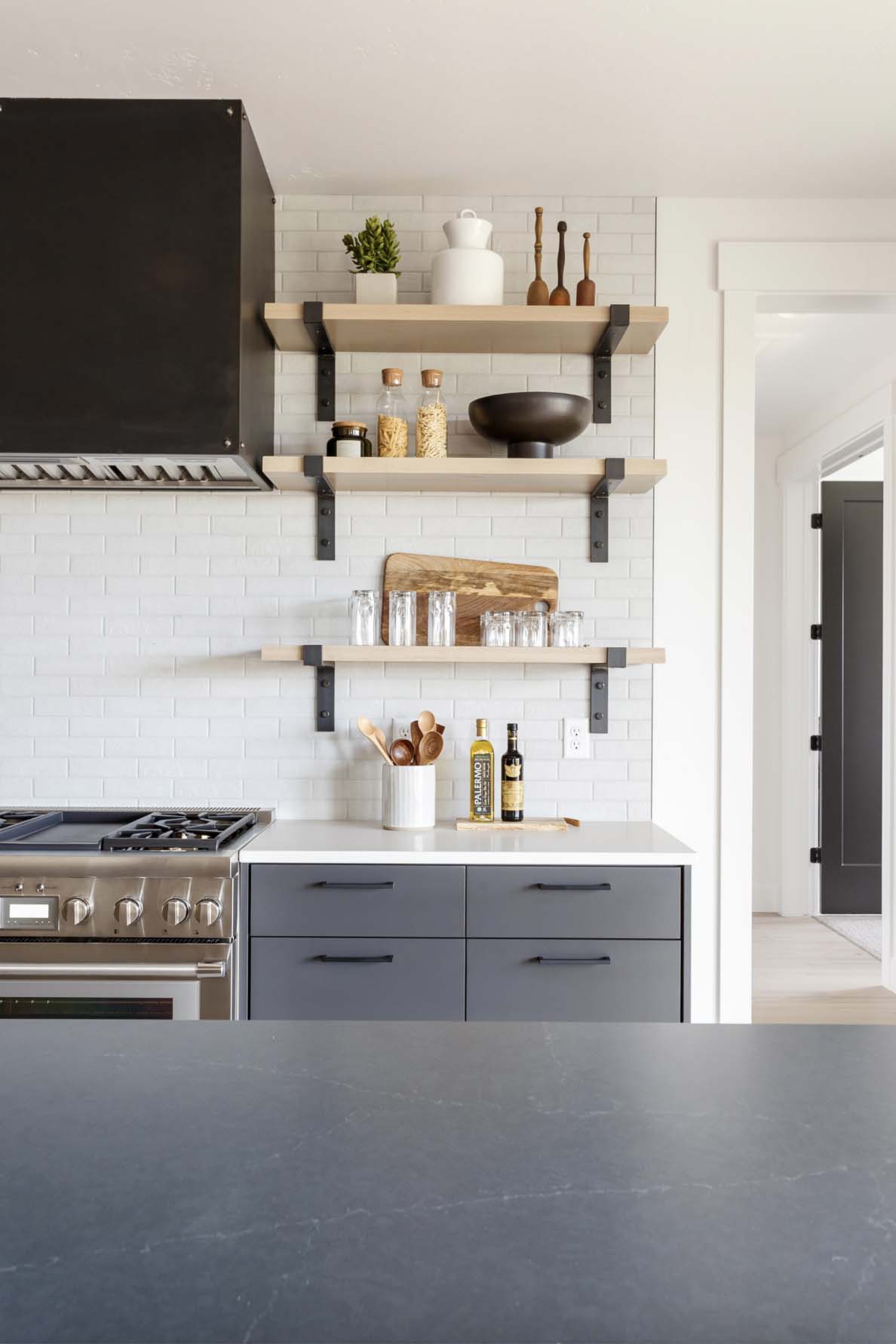 modern kitchen range and open shelf wall detail