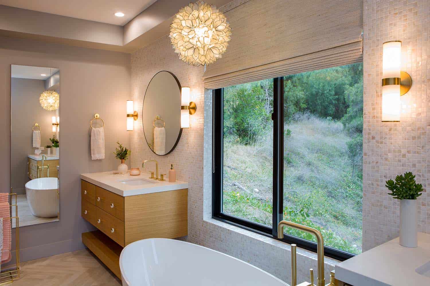 freestanding tub with a window view of the canyon trees
