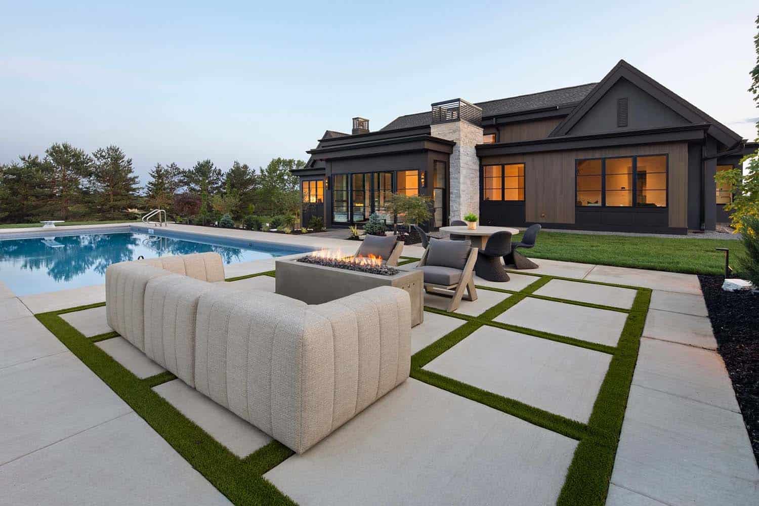 modern rambler home patio with outdoor furniture at dusk