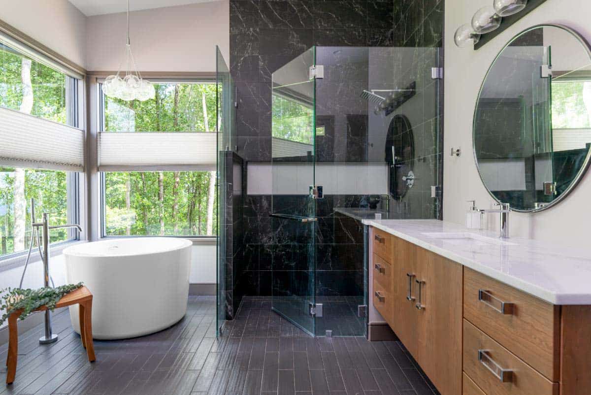 moody modern bathroom with a freestanding tub