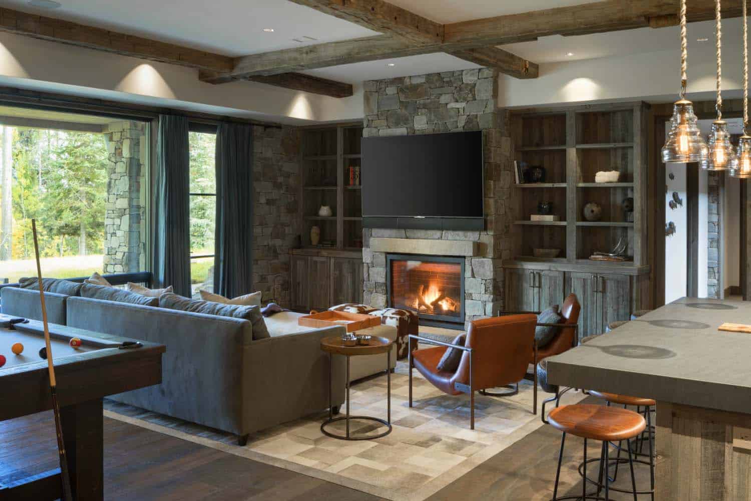 mountain modern lower level family room with a fireplace