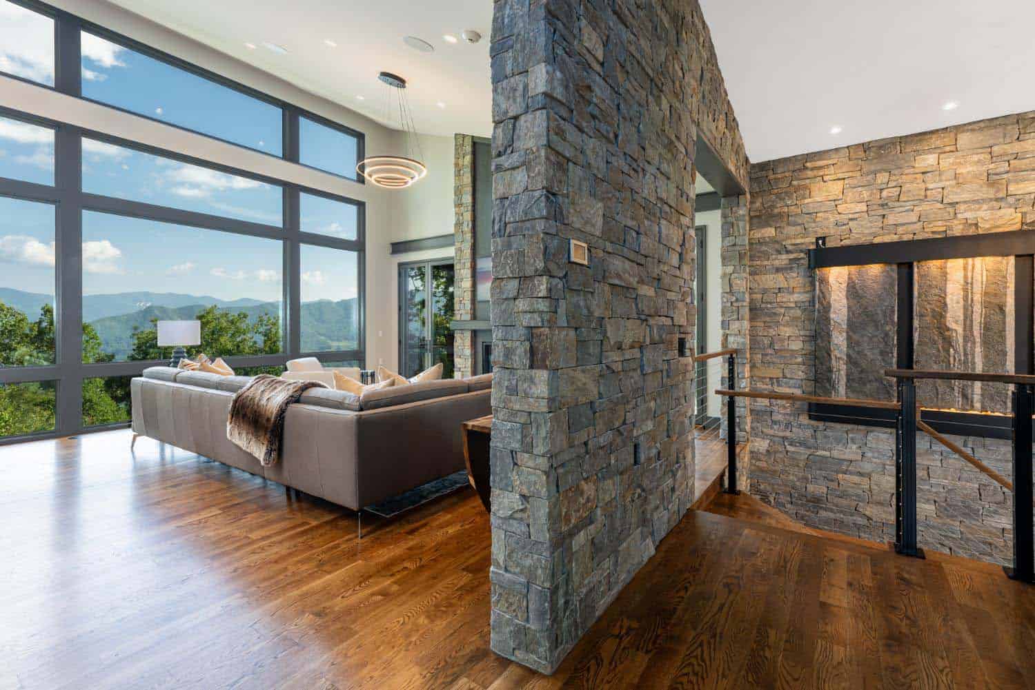 modern living room with a stone divider wall