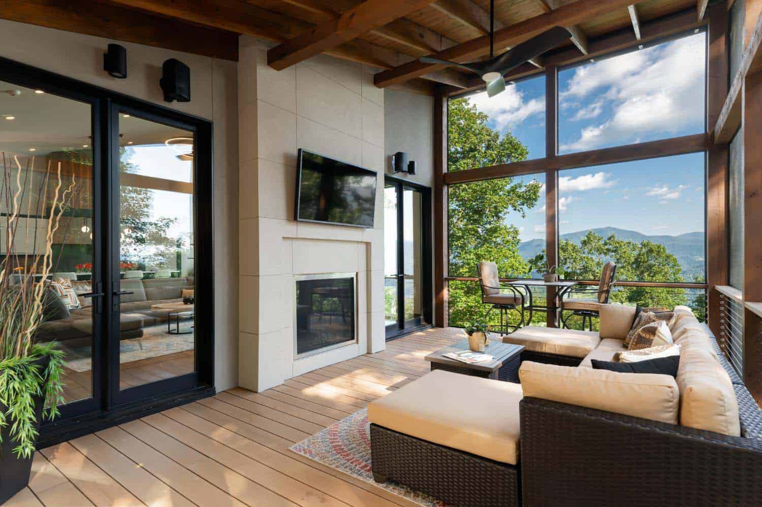 modern screened porch with a fireplace and mountain views