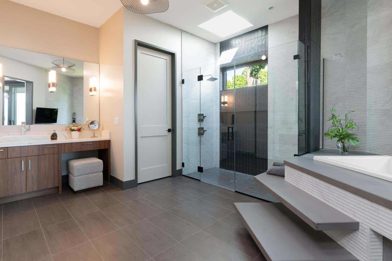 modern bathroom with an integrated tub and shower with a skylight