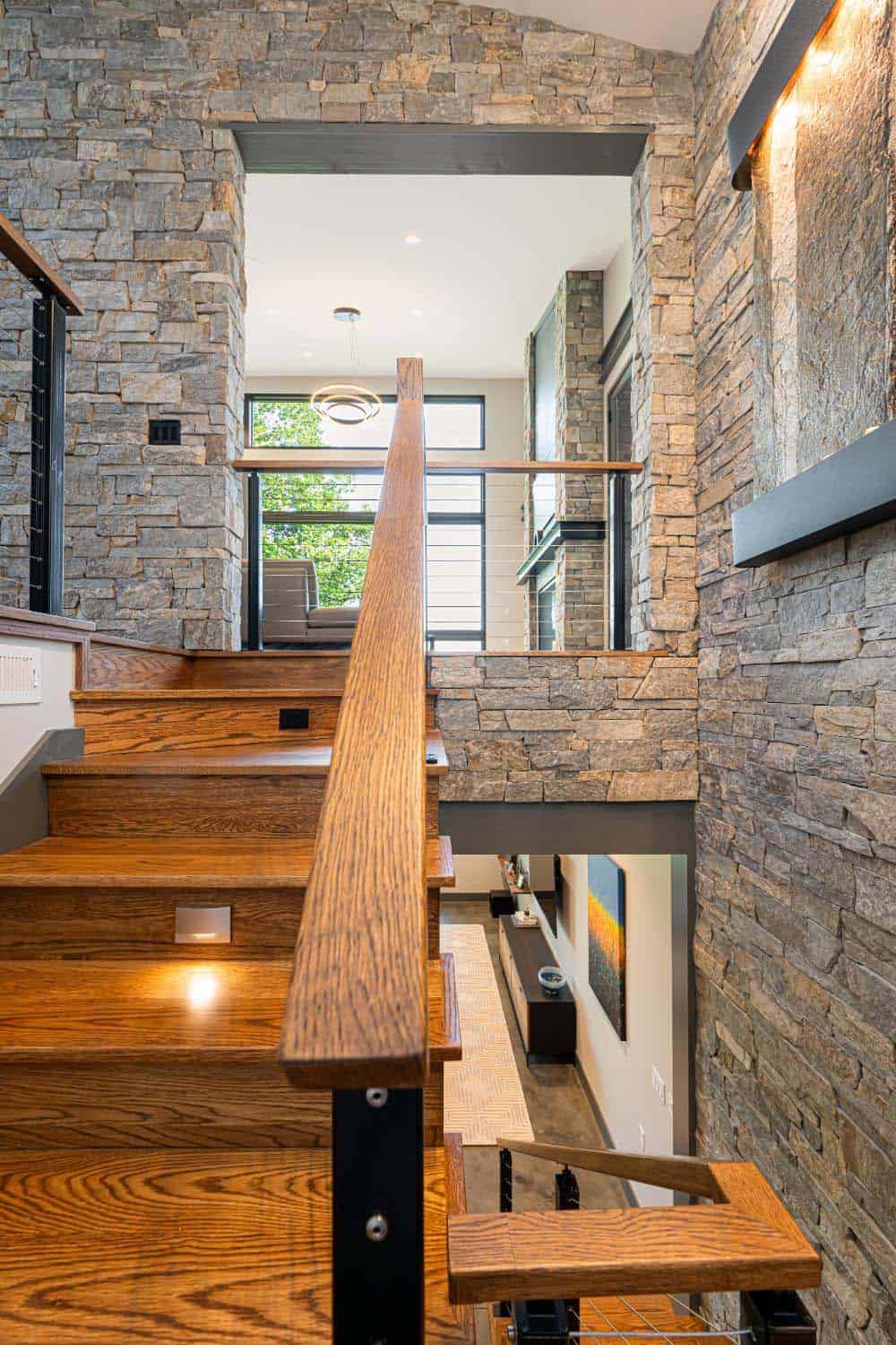 modern staircase with stone clad walls