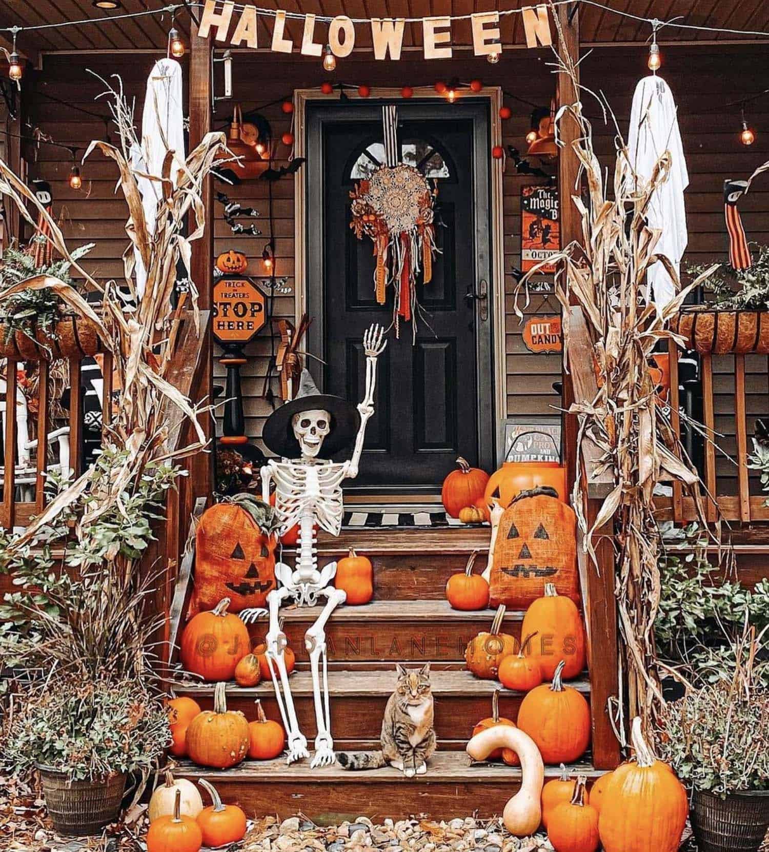 front porch with Halloween decorations including a skeleton and pumpkins