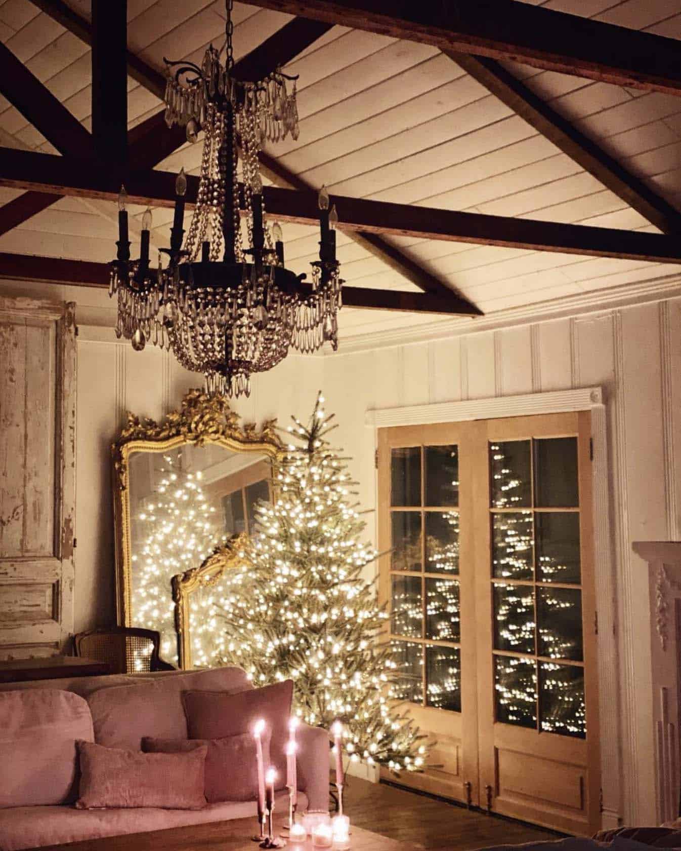 rustic and romantic living room with a lighted Christmas tree in the evening