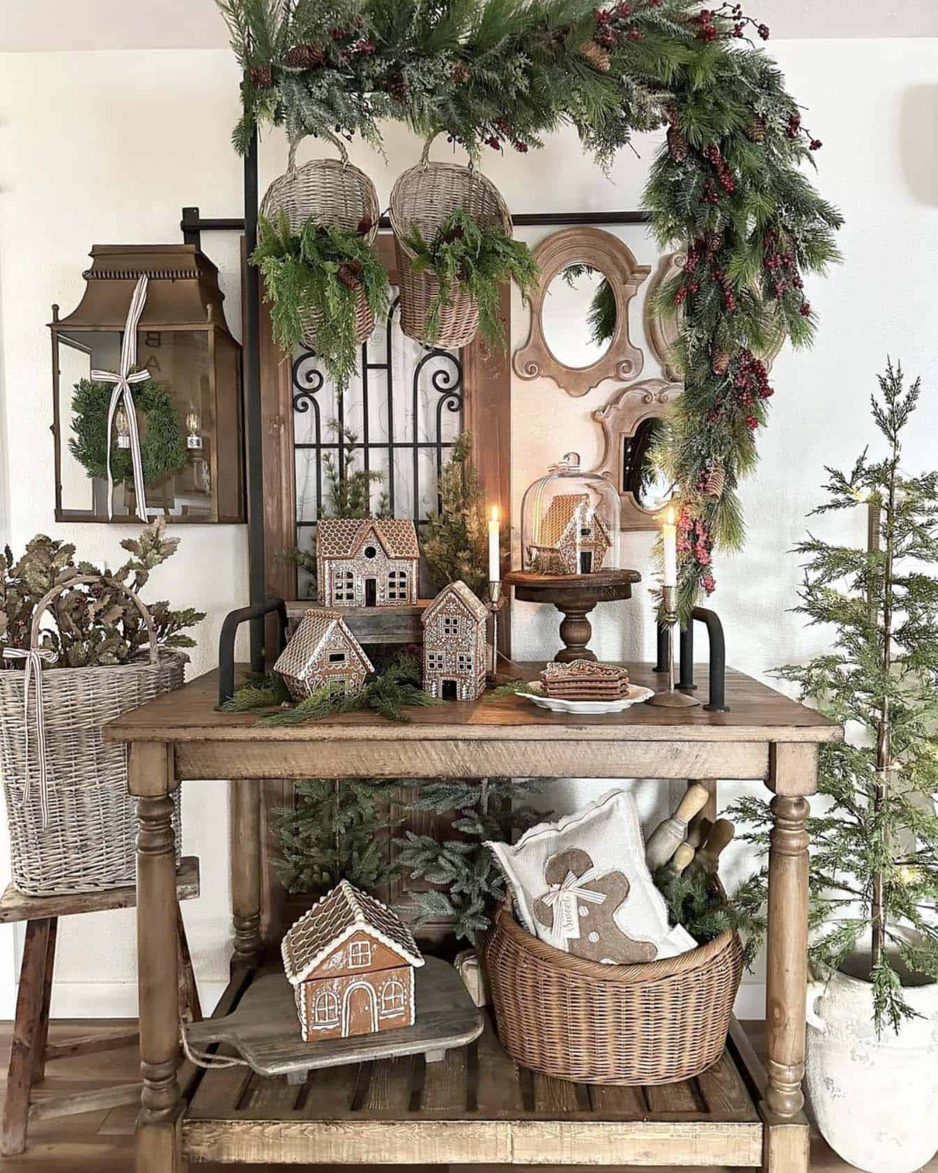 entry console table styled with gingerbread houses and garland, and accented with a Christmas tree