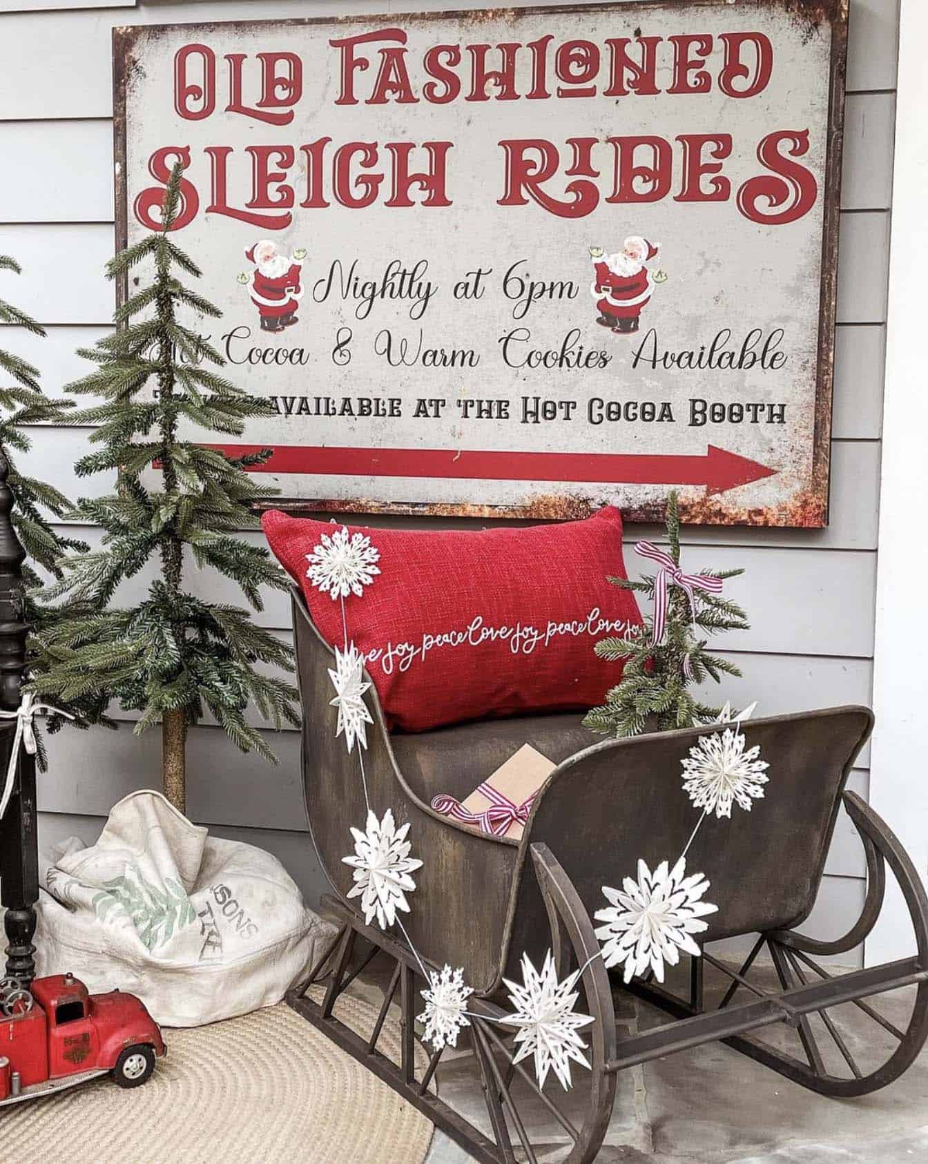 vintage style Christmas front porch decor with a sleigh and sign