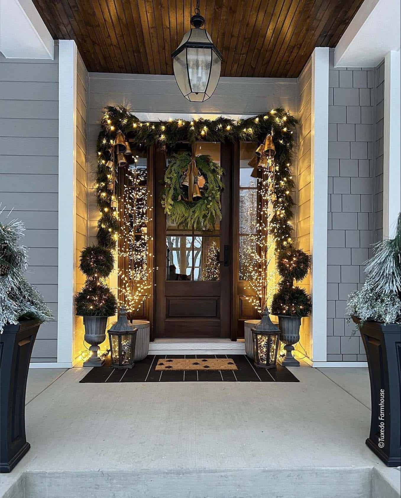 Christmas decorated front door with lighted faux greenery