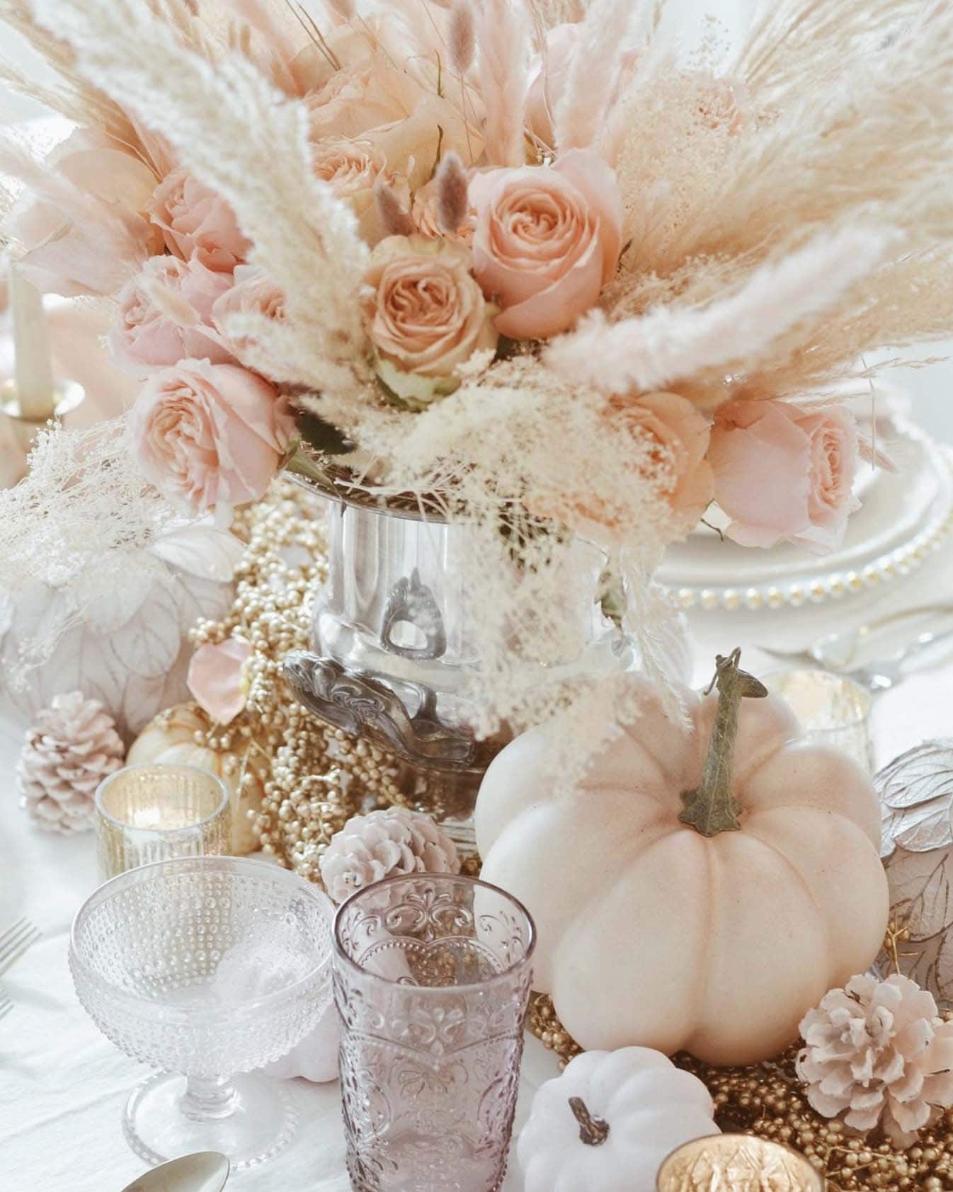 thanksgiving dining table decor with a pastel color palette of florals and pumpkins 