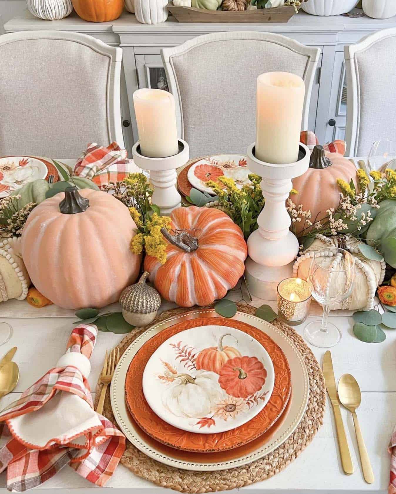 festive thanksgiving tablescape with a pumpkin and candle centerpiece