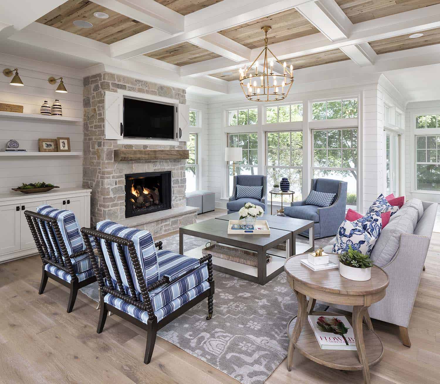 coastal farmhouse style living room with a fireplace and large windows