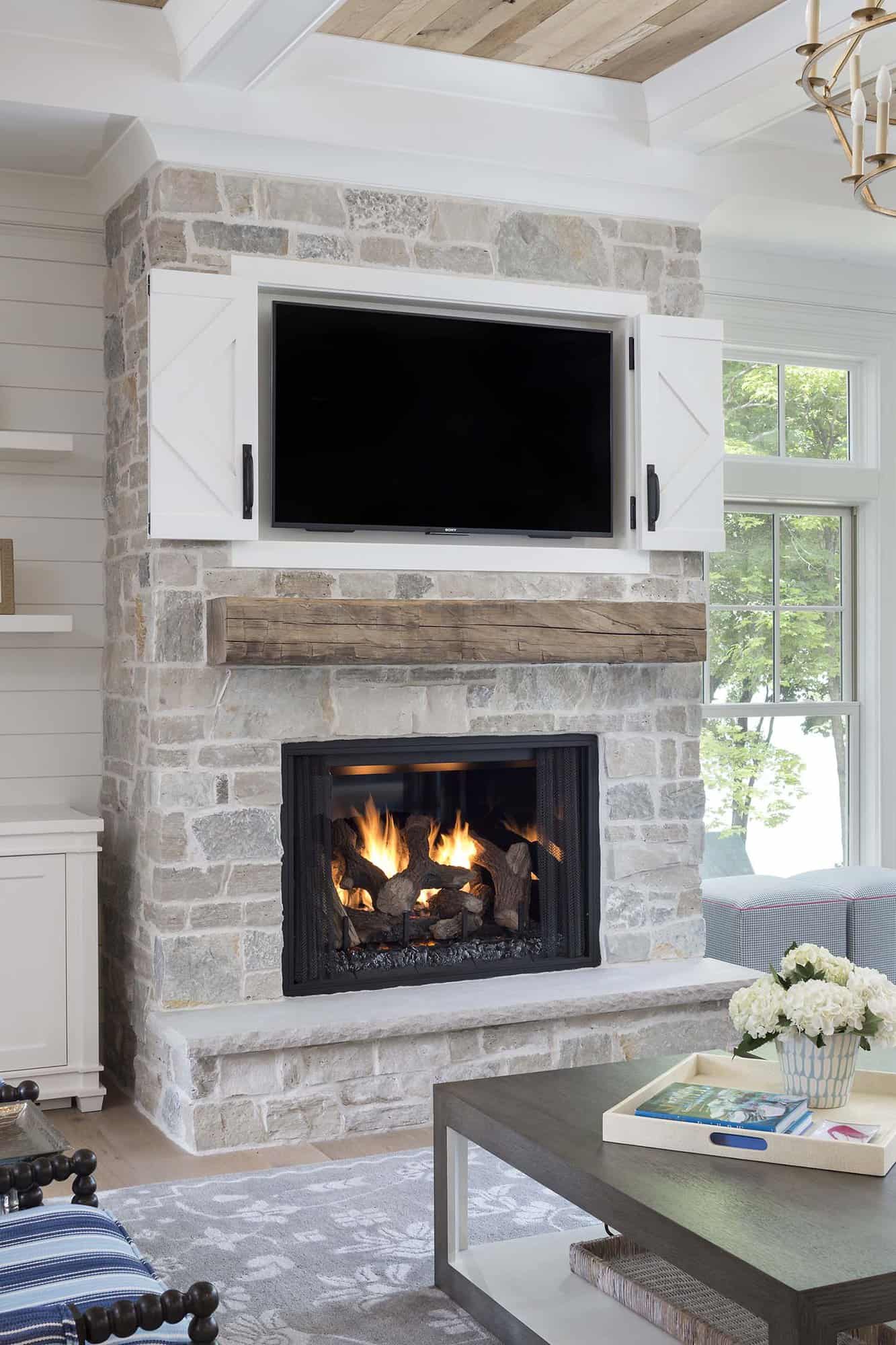 coastal farmhouse style living room fireplace with a tv mounted above the mantel