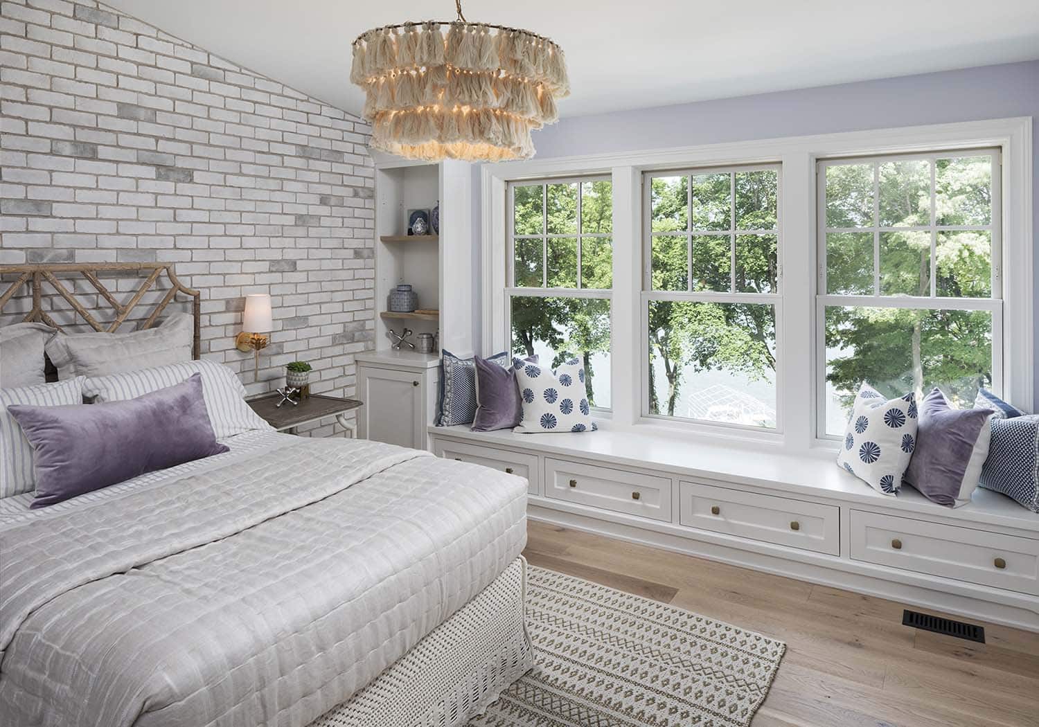 coastal farmhouse style guest bedroom with a built-in window seat