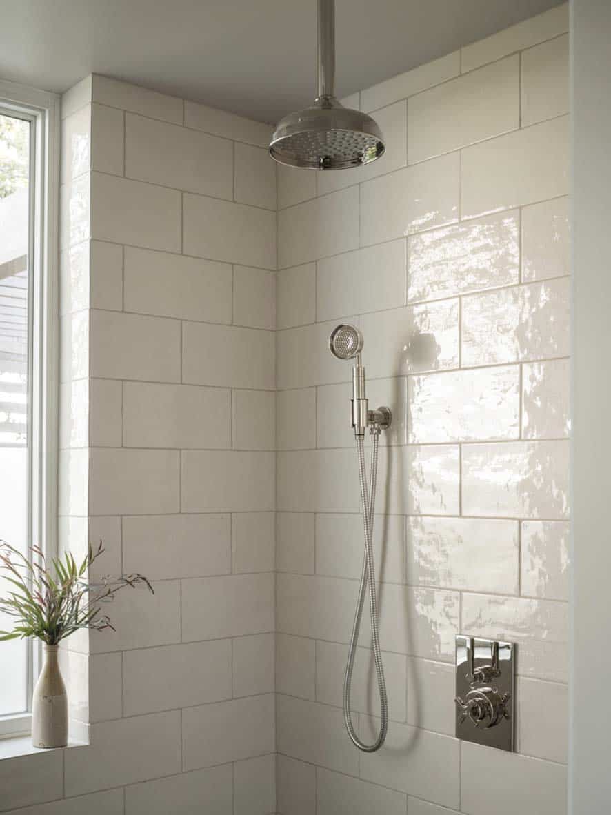 contemporary bathroom wit a white tile shower