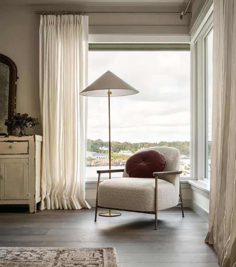 contemporary bedroom reading nook in front of a window with a view