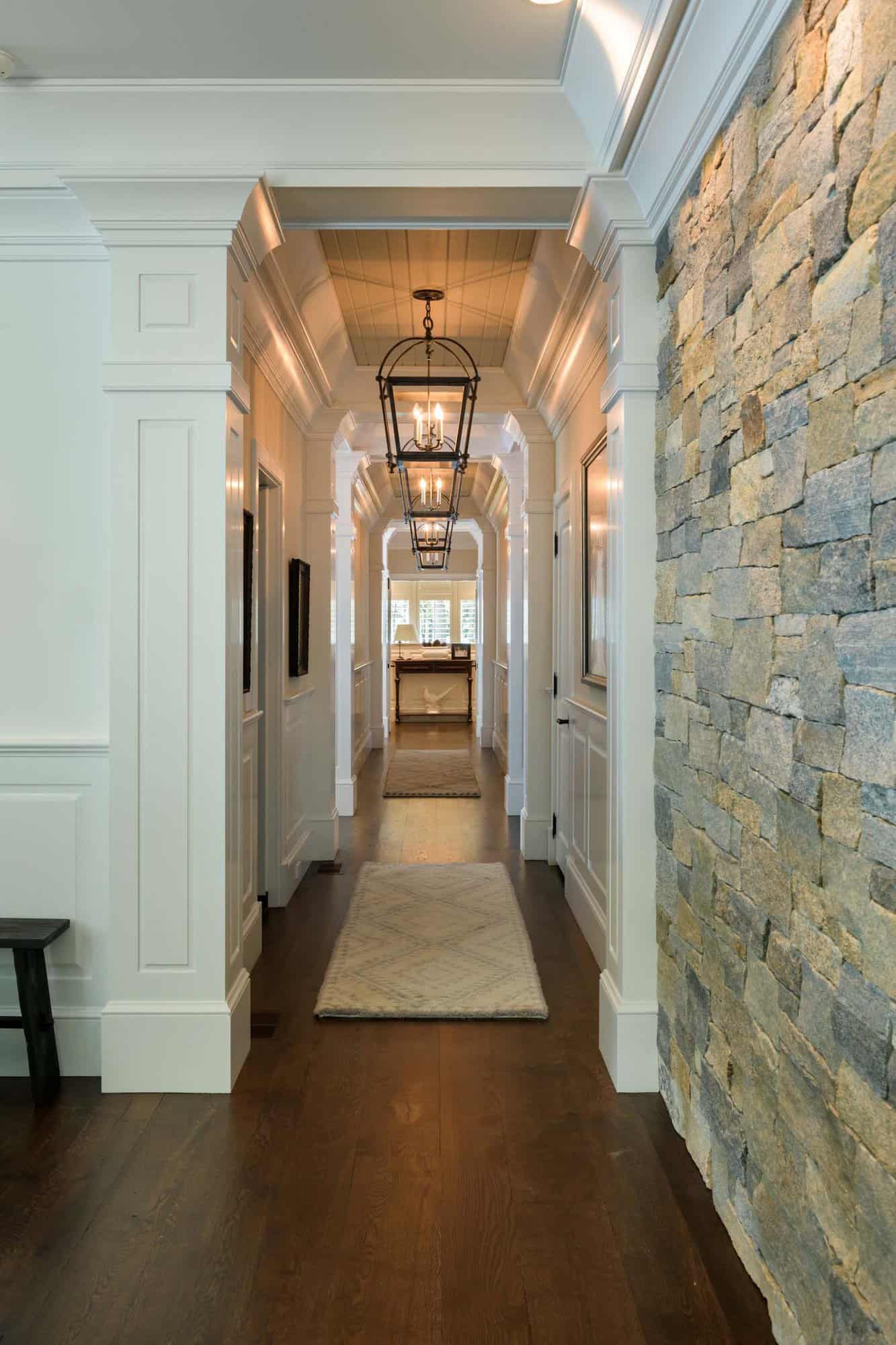 contemporary home hallway with stone and panel walls