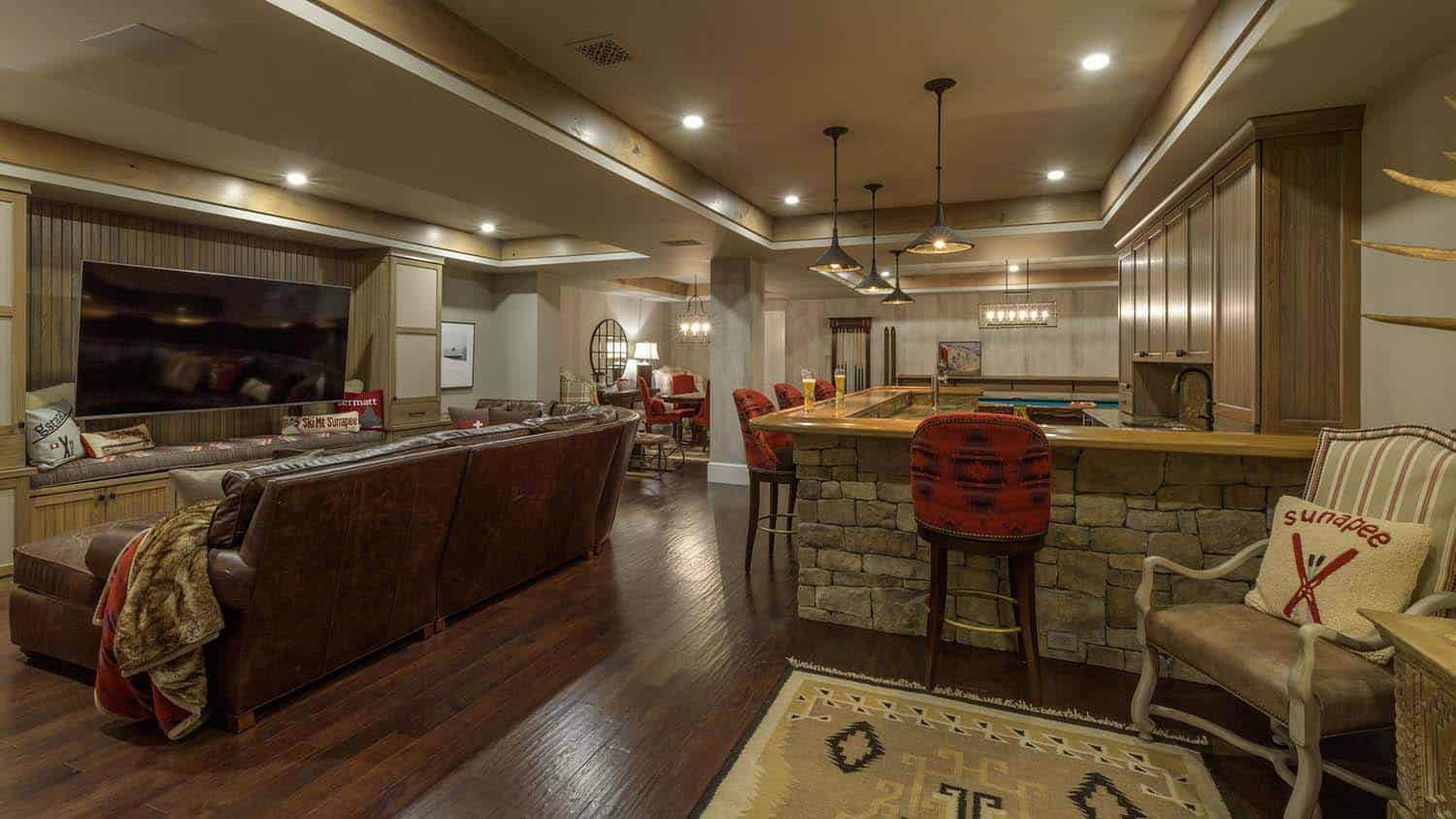contemporary lower level home bar and family room