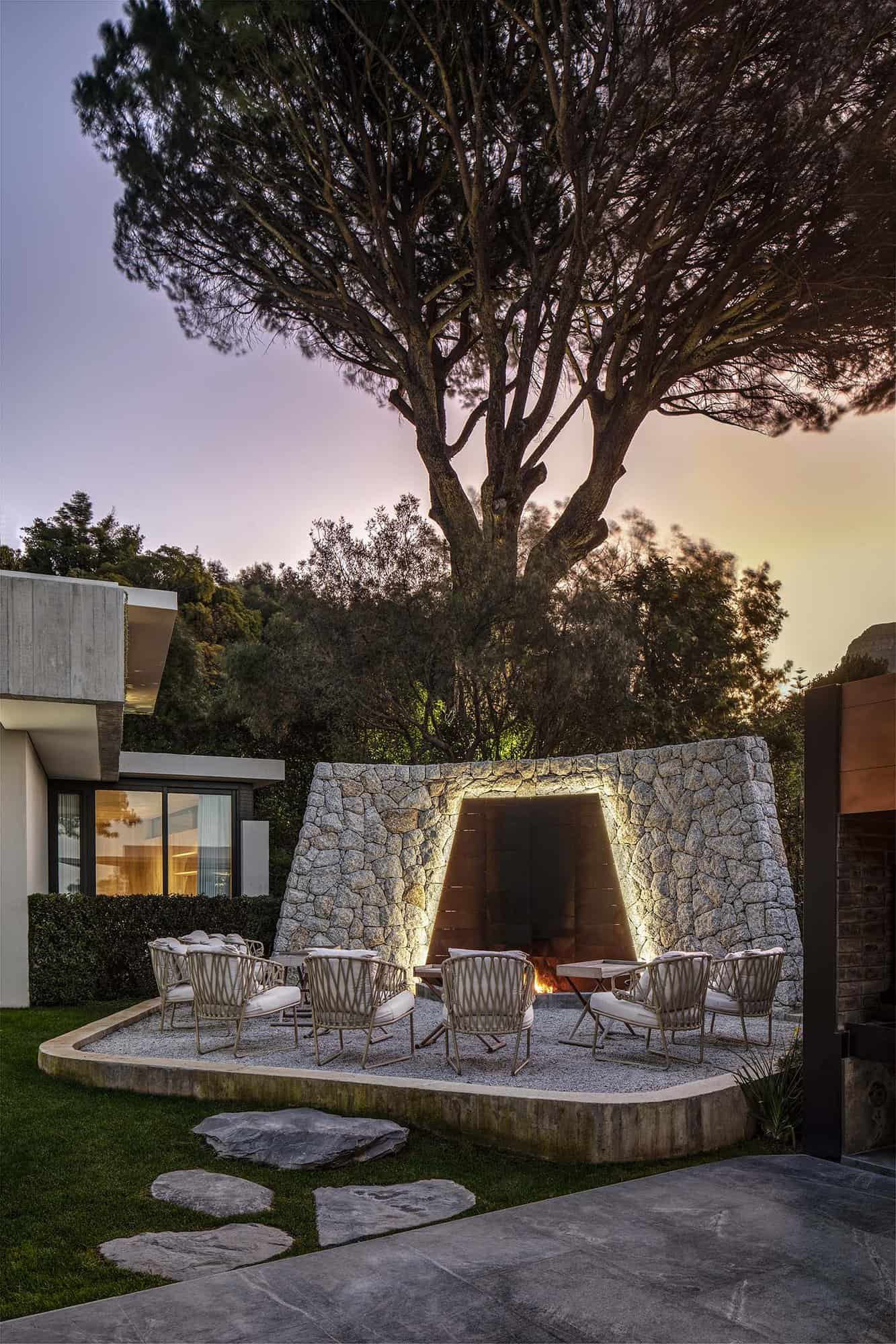 contemporary home exterior patio with a fireplace and outdoor furniture